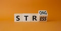 Strong Stress symbol. Turned wooden cubes with words Strong Stress. Beautiful orange background. Business and Strong Stress Royalty Free Stock Photo