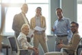 Strong and successful team. Group of happy multiracial business people smiling at camera while having a meeting at Royalty Free Stock Photo