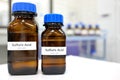 Strong sulfuric acid chemical in brown amber glass bottle inside a laboratory with copy space. Royalty Free Stock Photo