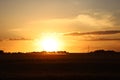 Sunset over agricultural field at harvest time Royalty Free Stock Photo