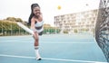 Strong tennis player hitting a ball during a match. Young girl making a facial expression during a game of tennis. Angry Royalty Free Stock Photo