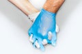 Strong together, couple holding hands with latex gloves