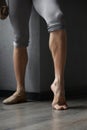 Strong trained legs of male ballet dancer cropped shot