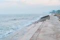 Strong waves hit concrete sea barrier in the evening