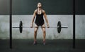 Strong, weight lifting and woman with barbell in gym for training, exercise and intense workout. Fitness, deadlift and