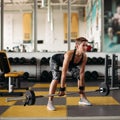 Strong woman with athletic body doing exercises with barbell in gym. Royalty Free Stock Photo