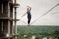 Strong and active young woman balancing on a slackline