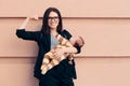 Strong Woman in Business Outfit Holding Baby Royalty Free Stock Photo