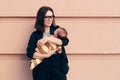 Strong Woman in Business Outfit Holding Baby Royalty Free Stock Photo