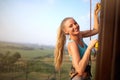 Strong woman and business success concept. Young caucasian pretty smiling woman practicing climbing on artificial rock