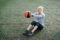 Strong woman doing seated medicine ball twist