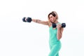 Strong woman punching with barbells in hands during boxing class on white background. One girl working out in studio Royalty Free Stock Photo