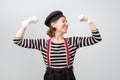 Strong woman showing her muscularity. Funny mime showing her power