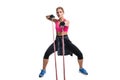 Strong woman using a resistance band in her exercise routine. Young woman performs fitness exercises on white background