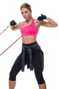 Strong woman using a resistance band in her exercise routine. Young woman performs fitness exercises on white background