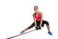 Strong woman using a resistance band in her exercise routine. Young woman performs fitness exercises on white background