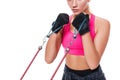 Strong woman using a resistance band in her exercise routine. Young woman performs fitness exercises on white background