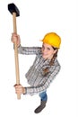 Strong woman using sledgehammer Royalty Free Stock Photo