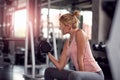 Strong woman doing exercises with dumbbells in gym Royalty Free Stock Photo