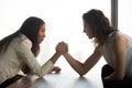 Strong women arm wrestle at work struggle for leadership Royalty Free Stock Photo