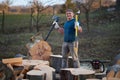 Strong woodman splitting logs