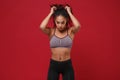 Strong young african american sports fitness woman in sportswear posing working out isolated on red wall background Royalty Free Stock Photo