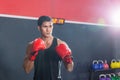 Strong young athlete sportsman Muay Thai boxer fighting in a gym, muscular handsome boxing man fighter Royalty Free Stock Photo