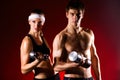 Strong young couple working out with dumbbells Royalty Free Stock Photo