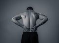 Strong young man suffering lower back pain in stress and bad posture Royalty Free Stock Photo
