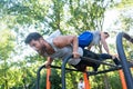 Strong young man supporting his friend while doing pull-ups Royalty Free Stock Photo