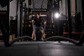 strong young man working out with battle ropes at crossfit gym Royalty Free Stock Photo