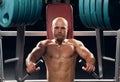 Strong young man working out on a chest press machine Royalty Free Stock Photo