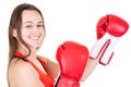 Strong young woman boxer in isolated whitenbackground wall wearing red boxing gloves Royalty Free Stock Photo