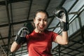 Strong young woman in boxing gear make a hitting motion