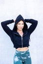 Strong Young Woman Flexing Muscles in Hoodie Royalty Free Stock Photo