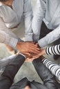 Stronger as a team. High angle shot of a group of businesspeople standing in a huddle together in an office lobby. Royalty Free Stock Photo