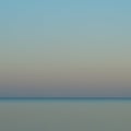 Strongly blurred photo of dawn over the ocean Royalty Free Stock Photo