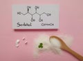 Structural chemical formula of sorbitol with white tablets and artificial sweetener in wooden spoon. Royalty Free Stock Photo