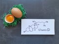 Structural chemical formula of vitamin D with fresh eggs. High vitamin D foods. Egg yolk, a natural source of vitamin D. Royalty Free Stock Photo