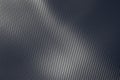 Detail of an industrial carbon fibre sheet in a full frame view showing the repeat diagonal pattern as light plays Royalty Free Stock Photo
