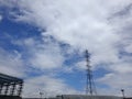 The structure of building with electric tower and blue sky as a background