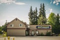 Structure with Far North Electronics sign located in Fairbanks, Alaska - Tall evergreen trees in