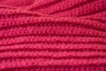 The structure of a knitted canvas of pink wool threads. Royalty Free Stock Photo