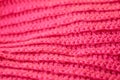 The structure of a knitted canvas of pink wool threads. Royalty Free Stock Photo