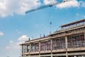 Structure of large building with worker working, crane and scaffold in construction site Royalty Free Stock Photo