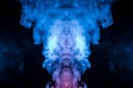 The structure of multi-colored smoke scattered on a black background and rising up as a pillar of fire of blue pink and white Royalty Free Stock Photo