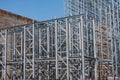 Structure of a new steel frame of a building on an industrial construction site. Against the background of the sky Royalty Free Stock Photo