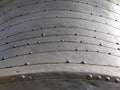 Structure of old metal with rivets. The surface of a space dish, UFO or submarine. Industrial metal construction