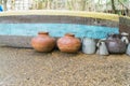 Structure outside in a compound with pots in front on gravel