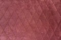 The structure of purple velor fabric. Modern upholstered velvet furniture. Creative vintage background. Quilted fabric